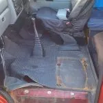 Double passenger seat removed, and starting to lift the rubber cab mat