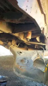 The old spring removed, with the trailing arm hanging down