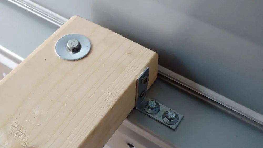 Bed supports and bolted into the side of the van