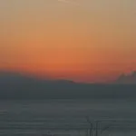A plane highlighted by the setting sun at Godrevy