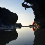 Matt climbing over a still pool of water at Godrevy