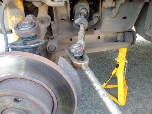 Using a fork to split the ball joint from the hub assembly