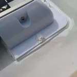 A panel corner mount - Sikaflexed to the roof, backed up with self tapping screws with sealant over the heads